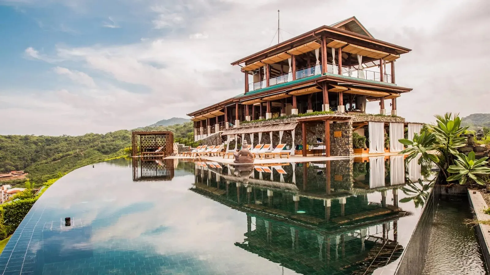 The tiered timber building and reflecting pool at Casa Chameleon