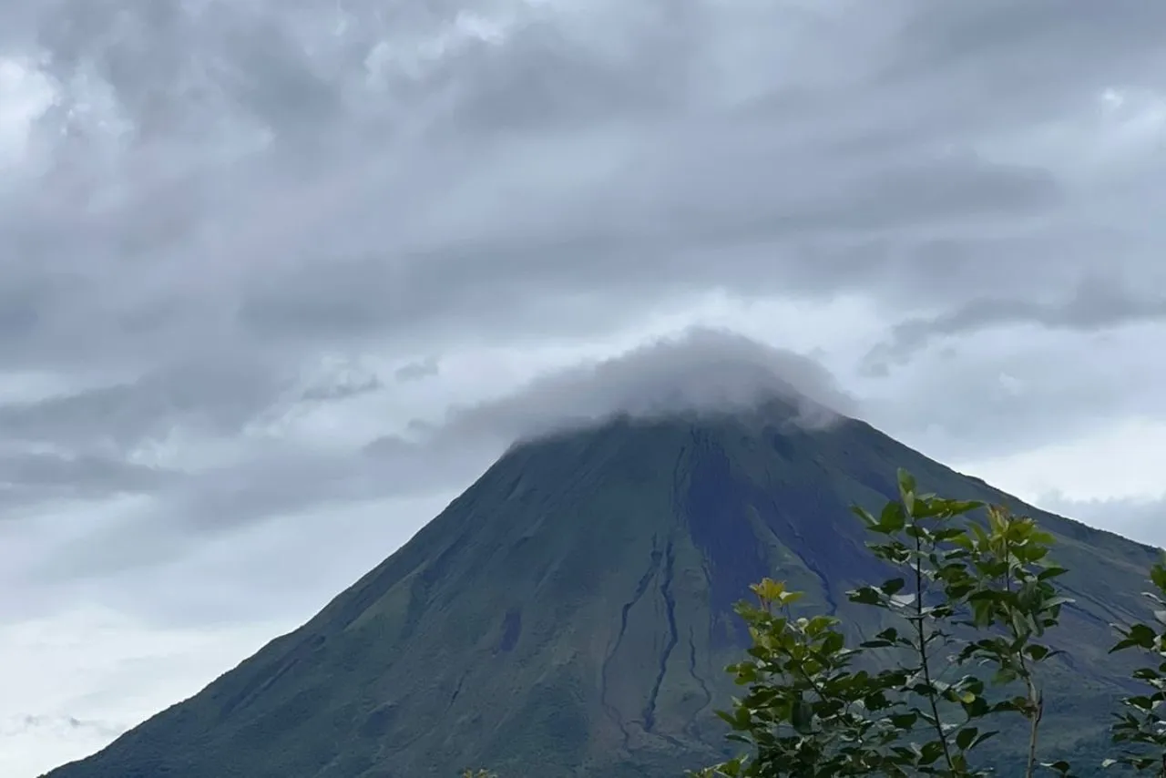 Arenal Volcano with its summit wrapped in cloud, seen from La Fortuna