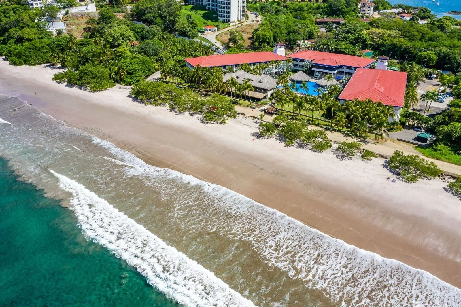 The red-roofed Margaritaville resort along the sand at Playa Flamingo