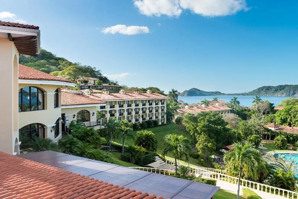 Tile-roofed buildings above the bay at the Occidental Papagayo