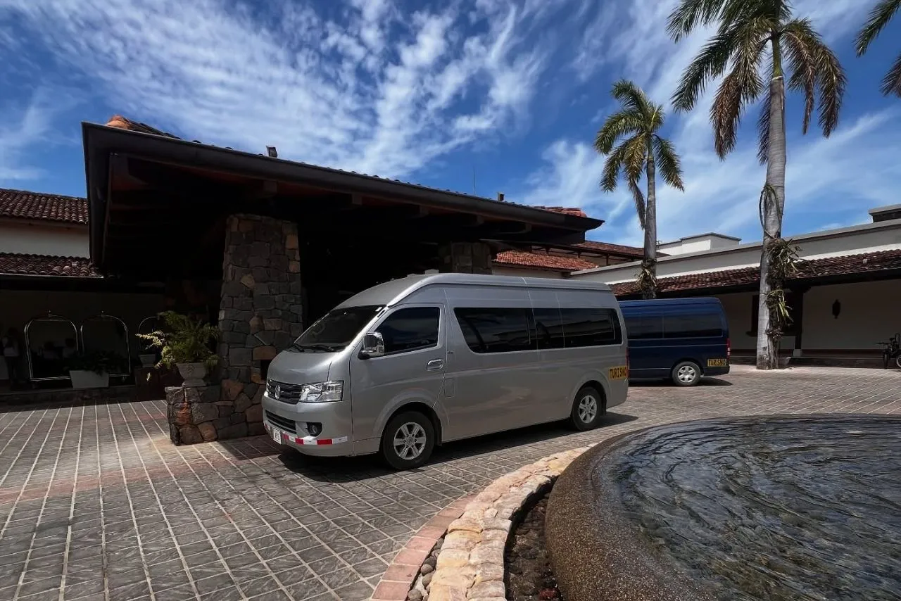 A Guana Shuttle Service van at a resort entrance in Guanacaste