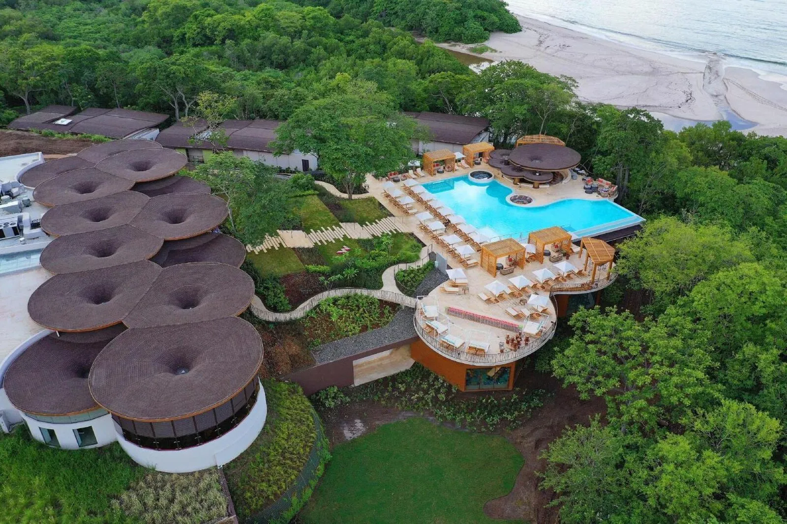 The curved roofs and pool of the W Costa Rica above Playa Conchal